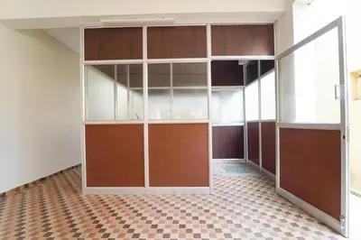 an empty closet with wooden doors and a checkered floor at Via Aarudra s Residency in Coimbatore