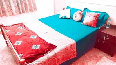 a bed with colorful pillows on it in a room at Rustic Retreat in Perumbavoor