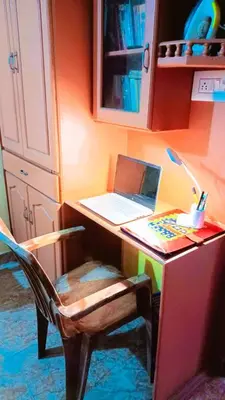 a desk with a laptop computer on top of it at Rustic Retreat in Perumbavoor