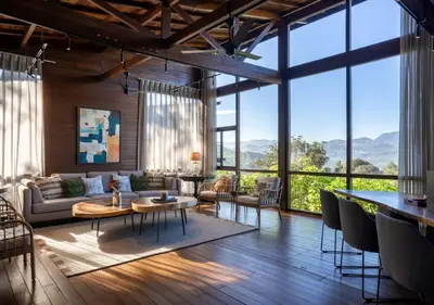 a living room with a lot of windows at LohonoStays Villa Amani 8B in Coonoor