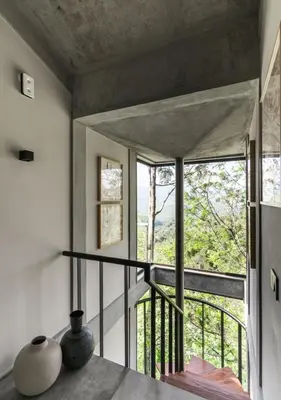 a room with a staircase and a large window at LohonoStays Amani Villa 9B in Coonoor