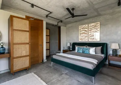 a bedroom with a large bed and a ceiling fan at LohonoStays Amani Villa 9B in Coonoor