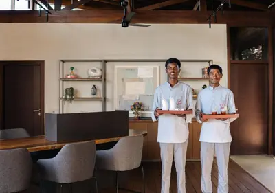 two men in white aprons standing in a room at LohonoStays Amani Villa 9B in Coonoor
