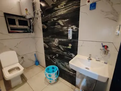 a bathroom with a sink and a toilet at Eve Service apartment in Mysore