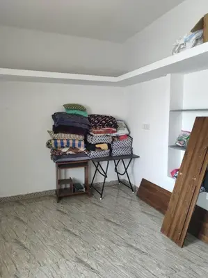 a room with a pile of blankets on a table at MMVK Homestay AC, Spacious & Comfortable Entire Home Just For You in Pollāchi