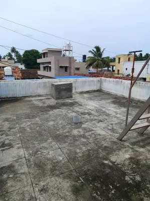 an empty parking lot in front of a building at MMVK Homestay AC, Spacious & Comfortable Entire Home Just For You in Pollāchi
