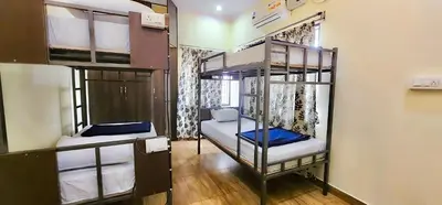 a room with two bunk beds in a room at Beedu - Backpackers Hostel in Mysore