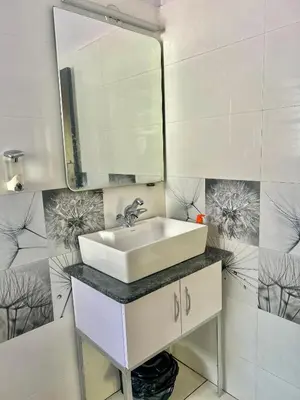 a bathroom with a sink and a mirror at Beedu - Backpackers Hostel in Mysore