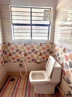 a bathroom with a toilet and a sink at Beedu - Backpackers Hostel in Mysore