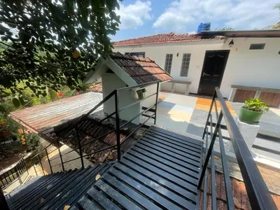 a set of stairs leading up to a house at Tjmaryland villa in Pinangode