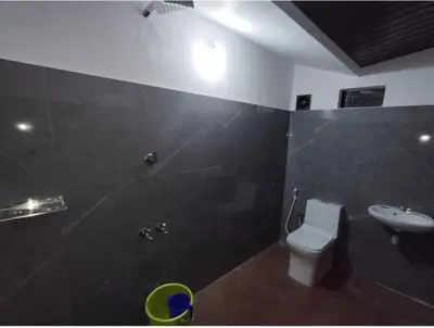 a bathroom with a toilet and a shower and a sink at Tjmaryland villa in Pinangode