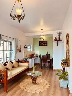 a living room with a couch and a table at Casa Serenity in Ooty