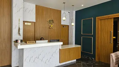 a kitchen with a counter and a door in a room at Prosland Hotel in Tirūr