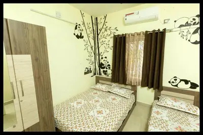 a bedroom with two beds in a room with panda decorations at Serene Meadows Resort in Kāramadai