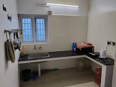 a kitchen with a sink and a window at Padmam Service Apartments - 2BHK in Singānallūr