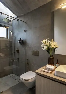 a bathroom with a toilet and a shower and a sink at LohonoStays Amani Villa 10A in Coonoor