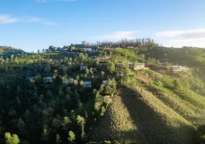 an aerial view of a hill with houses on it at LohonoStays Amani Villa 10A in Coonoor