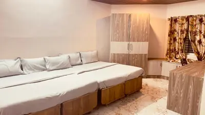 a bedroom with a large bed in a room at Mysuru-hotel in Mysore