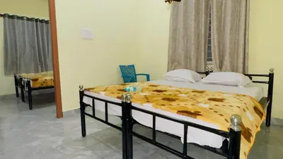 a bedroom with two twin beds and a mirror at Mysuru-hotel in Mysore