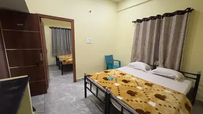 a bedroom with a bed and a mirror at Mysuru-hotel in Mysore