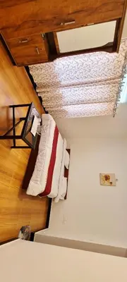 a room with a bed and a ceiling at AJ Groups B&B Residency in Ooty