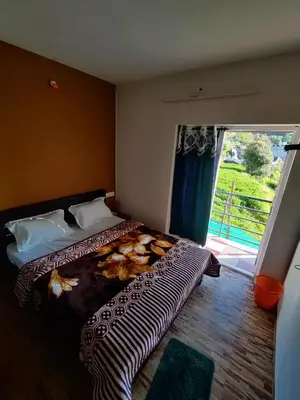 a bedroom with a bed and a large window at Ooty Horizon Heights in Ooty