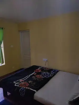 a bedroom with a bed in a room at Ooty Horizon Heights in Ooty