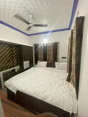 a bedroom with a large bed with a ceiling at Blue mount stay in Gūdalūr