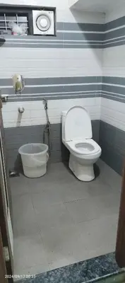 a bathroom with a toilet and a tub at Blue mount stay in Gūdalūr