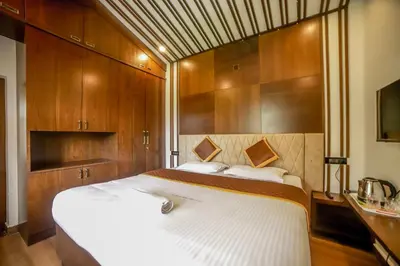a bedroom with two beds and wooden cabinets at The Haven by Xplore Indo in Ooty