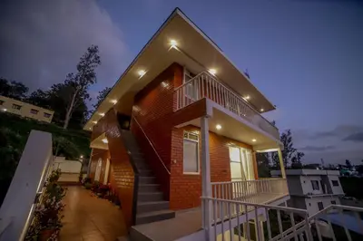 a house with a staircase in front of it at The Haven by Xplore Indo in Ooty