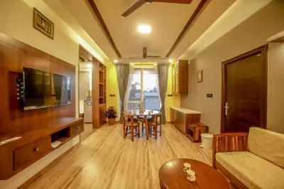 a living room with a table and a couch at The Haven by Xplore Indo in Ooty