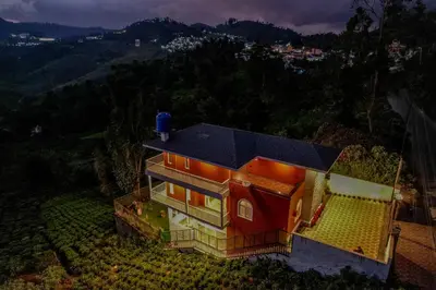 an aerial view of a house with a blue roof at The Haven by Xplore Indo in Ooty