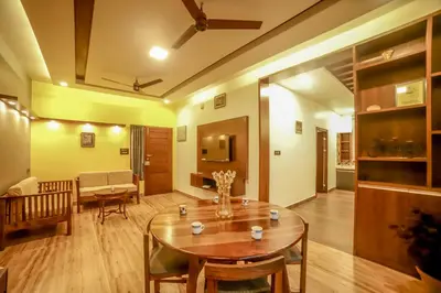 a living room with a table and a couch at The Haven by Xplore Indo in Ooty