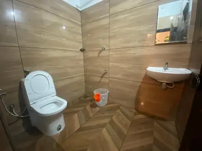 a small bathroom with a toilet and a sink at Plantation stay in Kuttyādi
