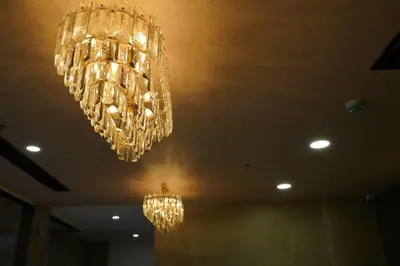 a group of chandeliers hanging from a ceiling at BINI Heritage in Trichūr