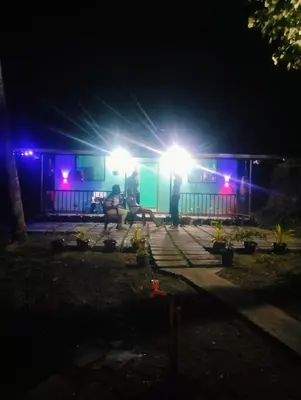 a man standing in front of a house at night at ADVI'S homestay in Agali