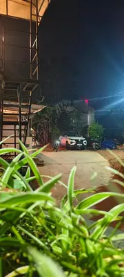 a car parked in a parking lot at night at Birdwing Cottage, Munnar in Munnar