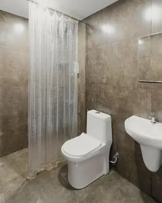a bathroom with a toilet and a sink at Lakedale Resorts in Thekkumkara