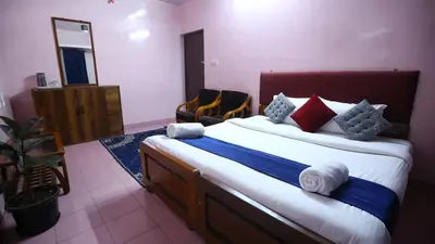 a bedroom with a large bed with towels on it at Janani Cottage in Ooty