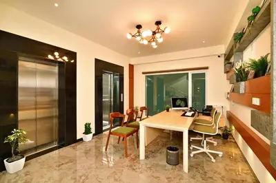 an office with a desk and chairs in a room at Eka Lyf Inn in Coimbatore