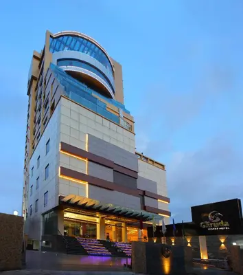a tall building with a lot of windows at The Garuda Hotels in Trichūr