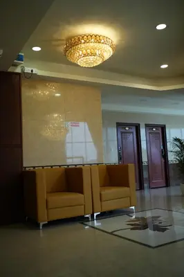 a waiting room with a couch in a building at Mazus Urban Express in Mysore