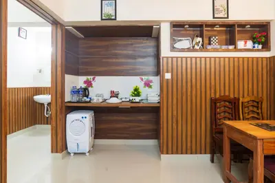 a room with a desk with a computer in it at Sancta Maria in Nedumbassery