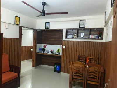 a room with wood paneling and a table and chairs at Sancta Maria in Nedumbassery