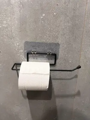 a roll of toilet paper hanging on a wall at SAHAR HOMEstay 02 in Mysore