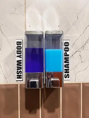 two bottles of blue liquid sitting on top of a counter at SAHAR HOMEstay 02 in Mysore