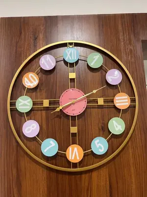 a clock that is on a wooden wall at SAHARHOMEstay O3 in Mysore