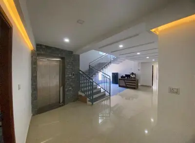 a hallway with a staircase in a house at moona apartments in Malappuram
