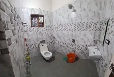 a bathroom with a toilet and a sink at 3 BHK HOUSE with nice facilities,Gate&Fence in Kunnamangalam